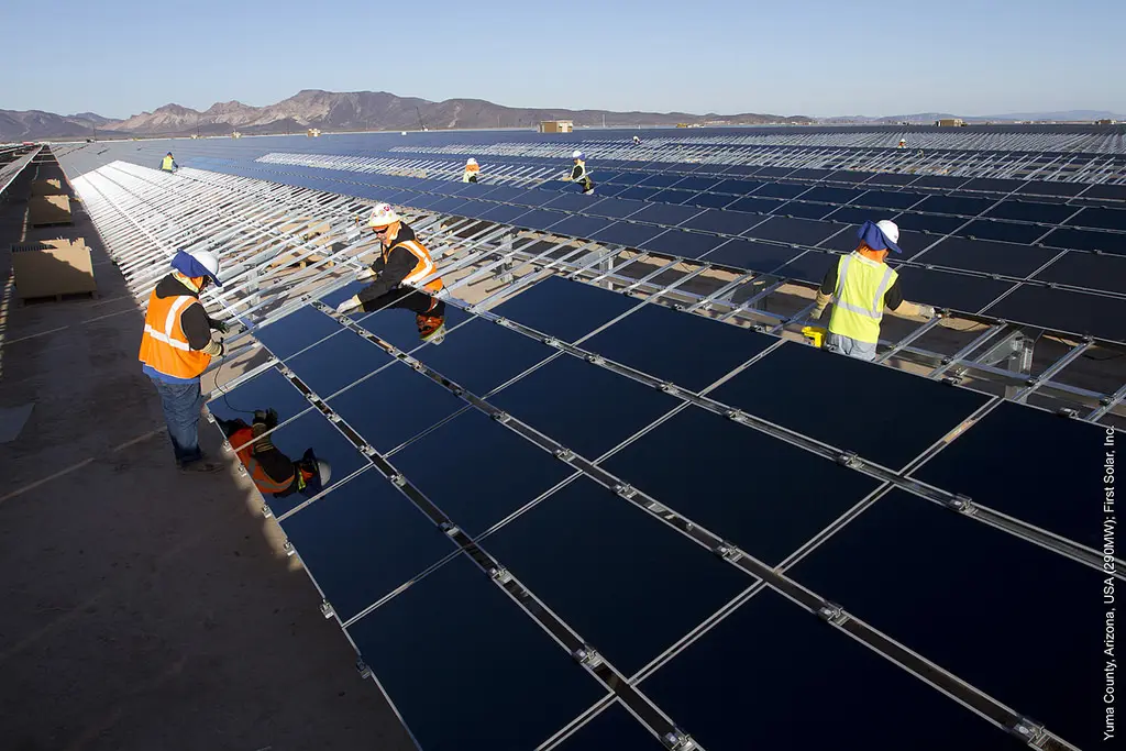 Commercial solar panels with multiple workers