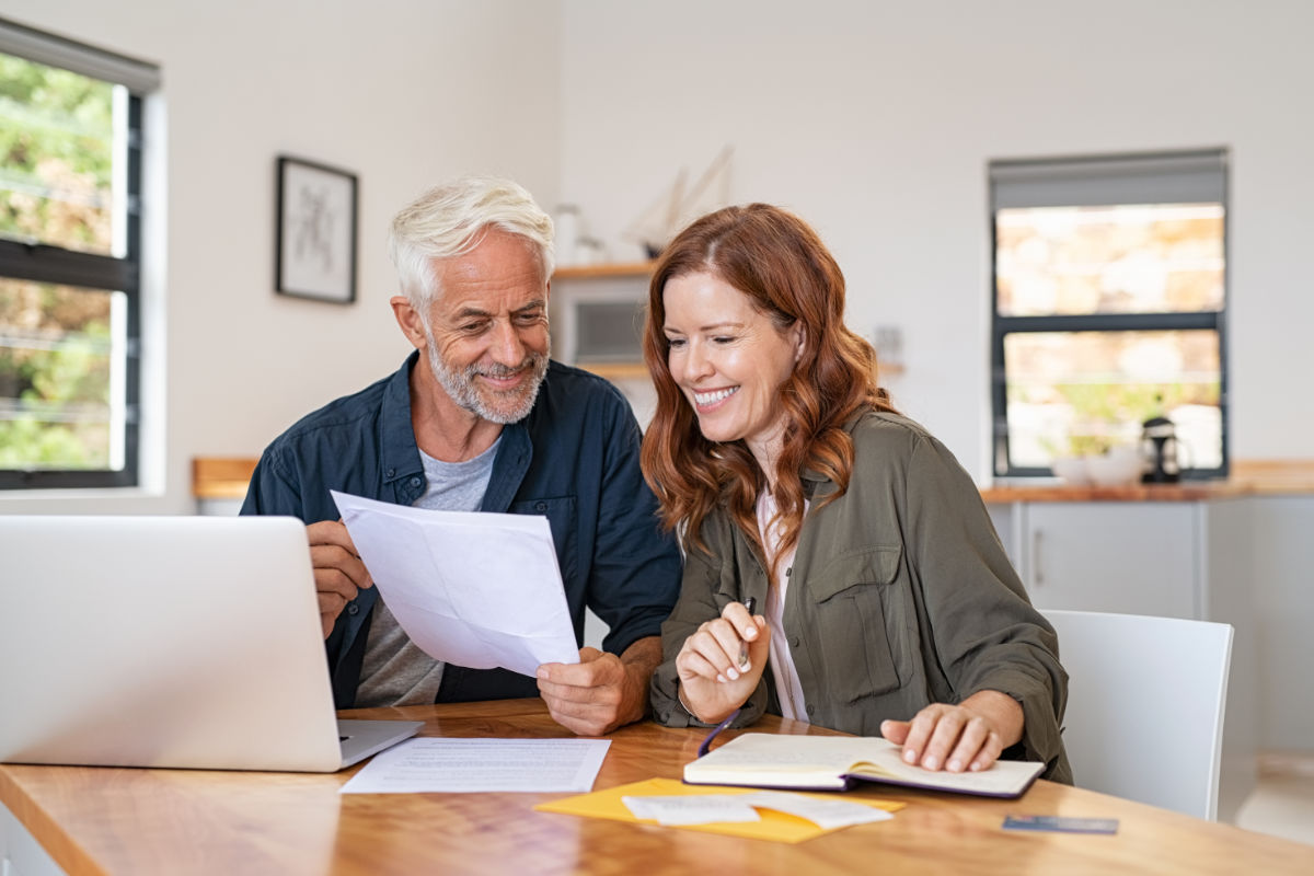 A couple reviewing Solar installation on a document