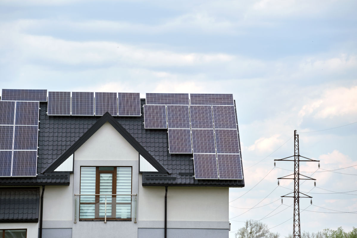 White home with dark roofing with Solar Panels Installed