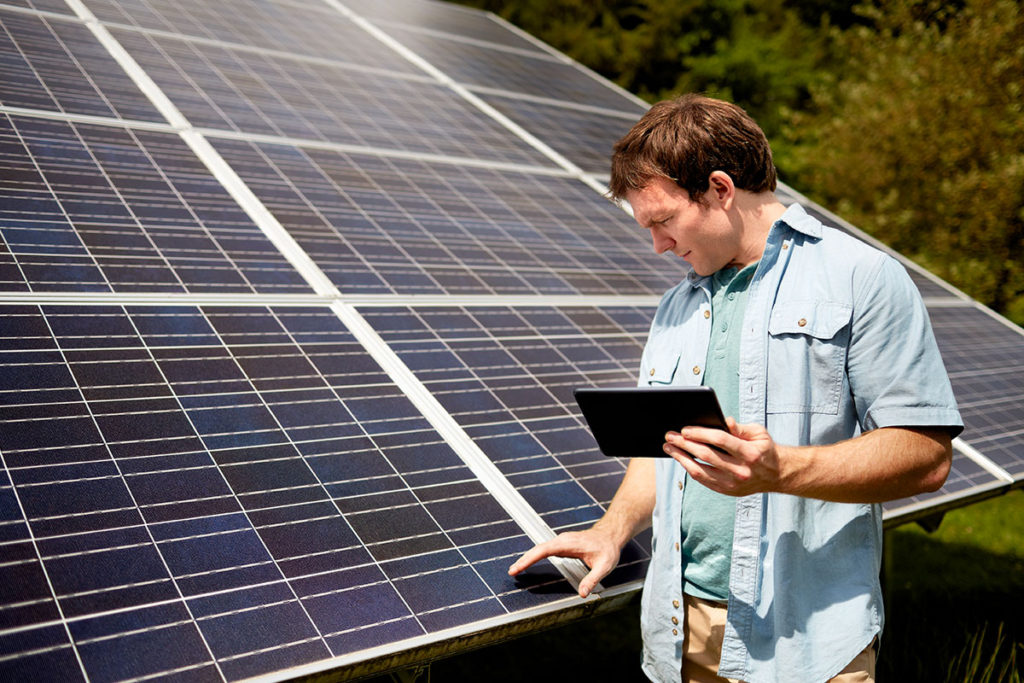 DIY homeowner reviewing a solar panel and the installation guide