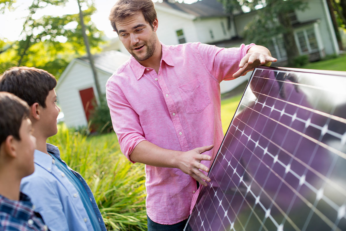 Young man demonstrating the benefits of solar to young students