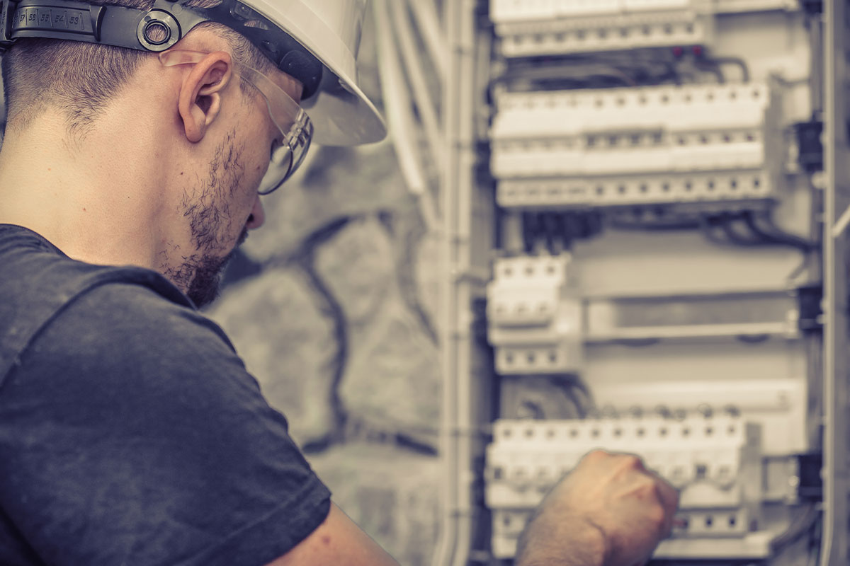 Young male electrician working on an electric panel