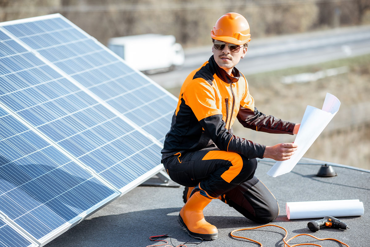 Solar technician installing new solar panels on a residential rooftop