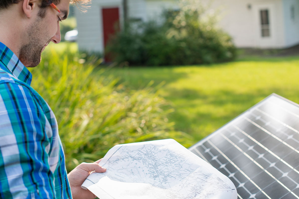 Young man reviewing plans for a new solar panel installation