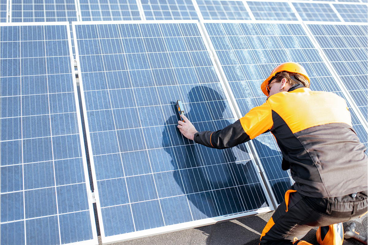 Technician reviewing solar output from various panels