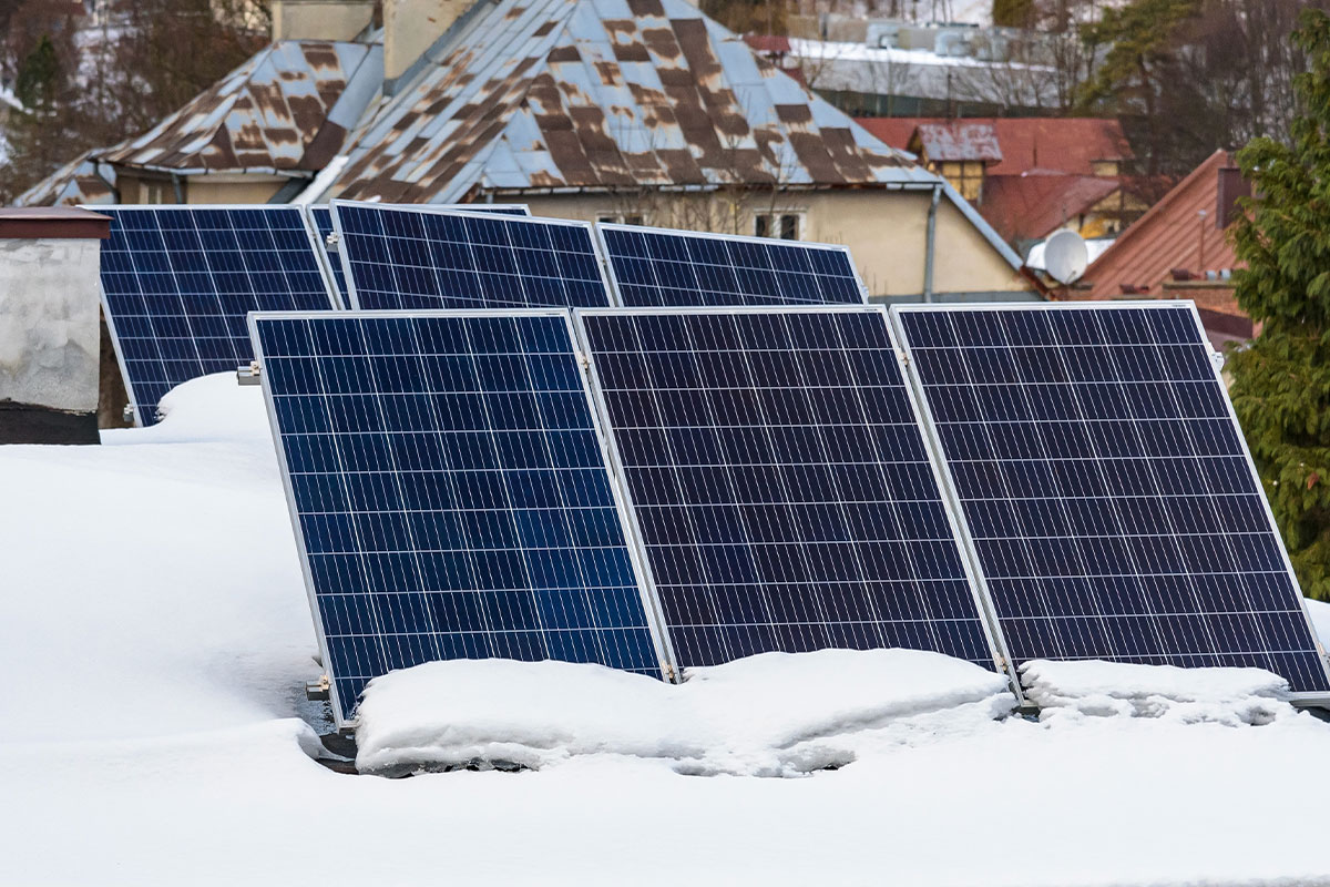 Six rooftop solar panels layered in snow