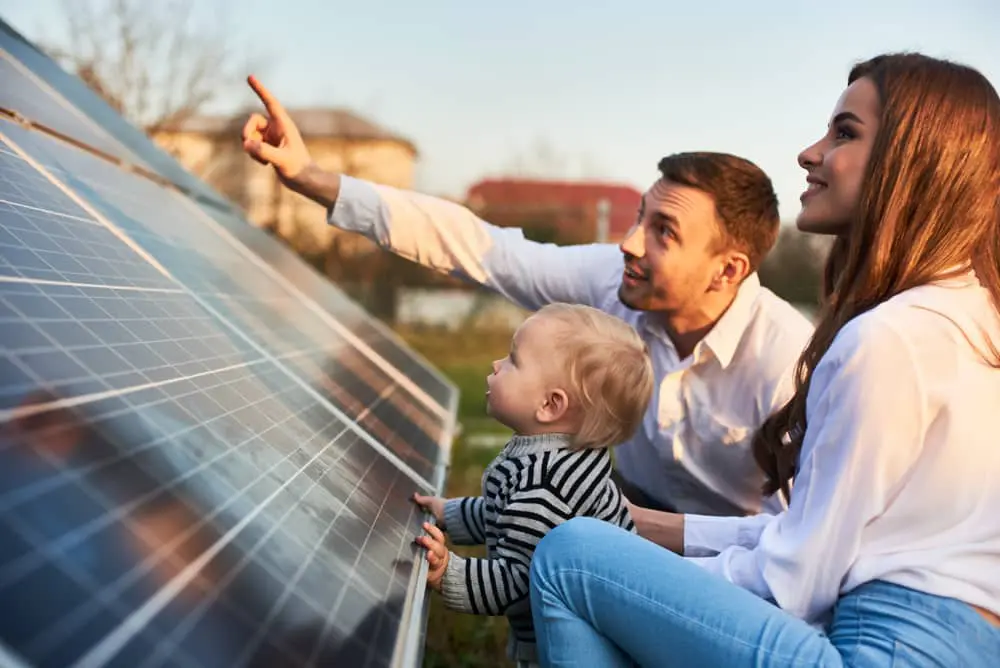 Young couple and child reviewing their new solar installation