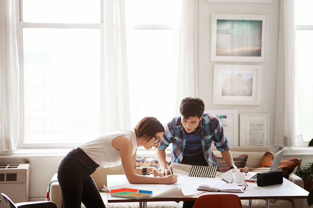 Young couple analyzing housing blueprints