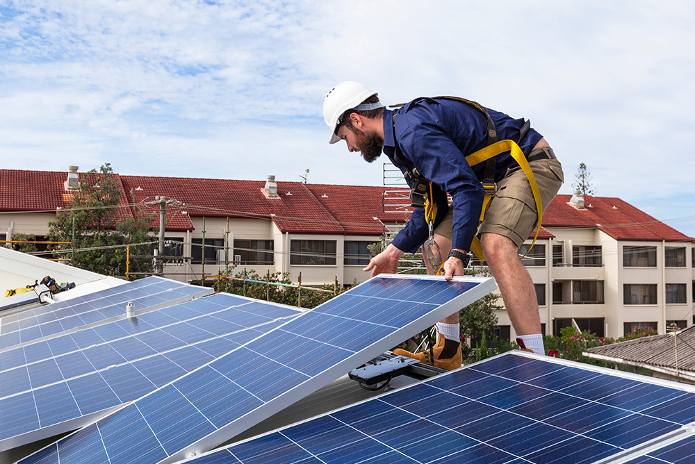 Man Laying down solar panels