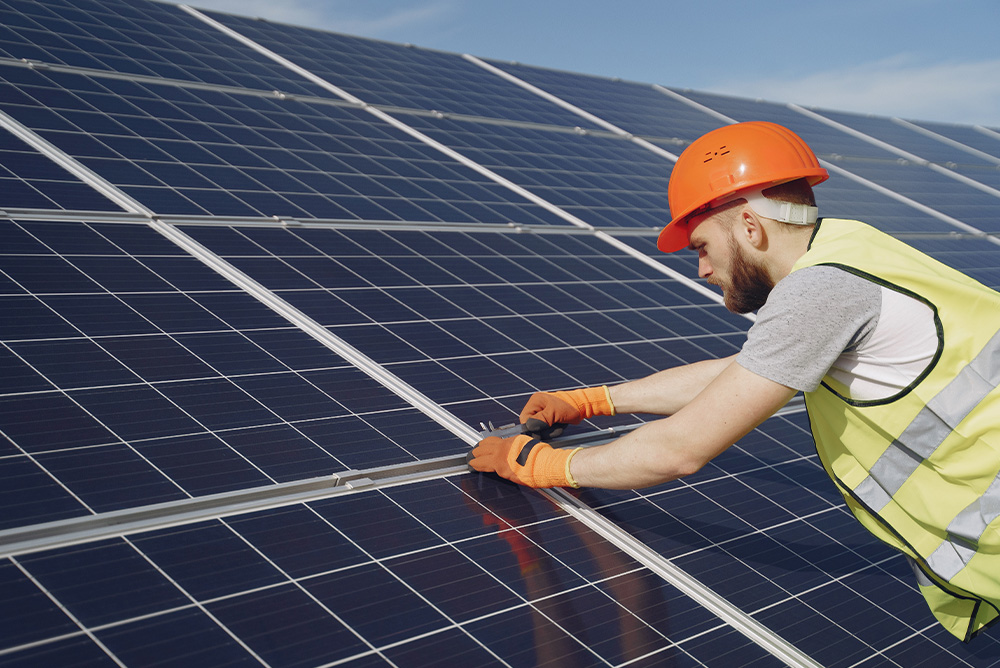 Man finalizing installation of solar panels