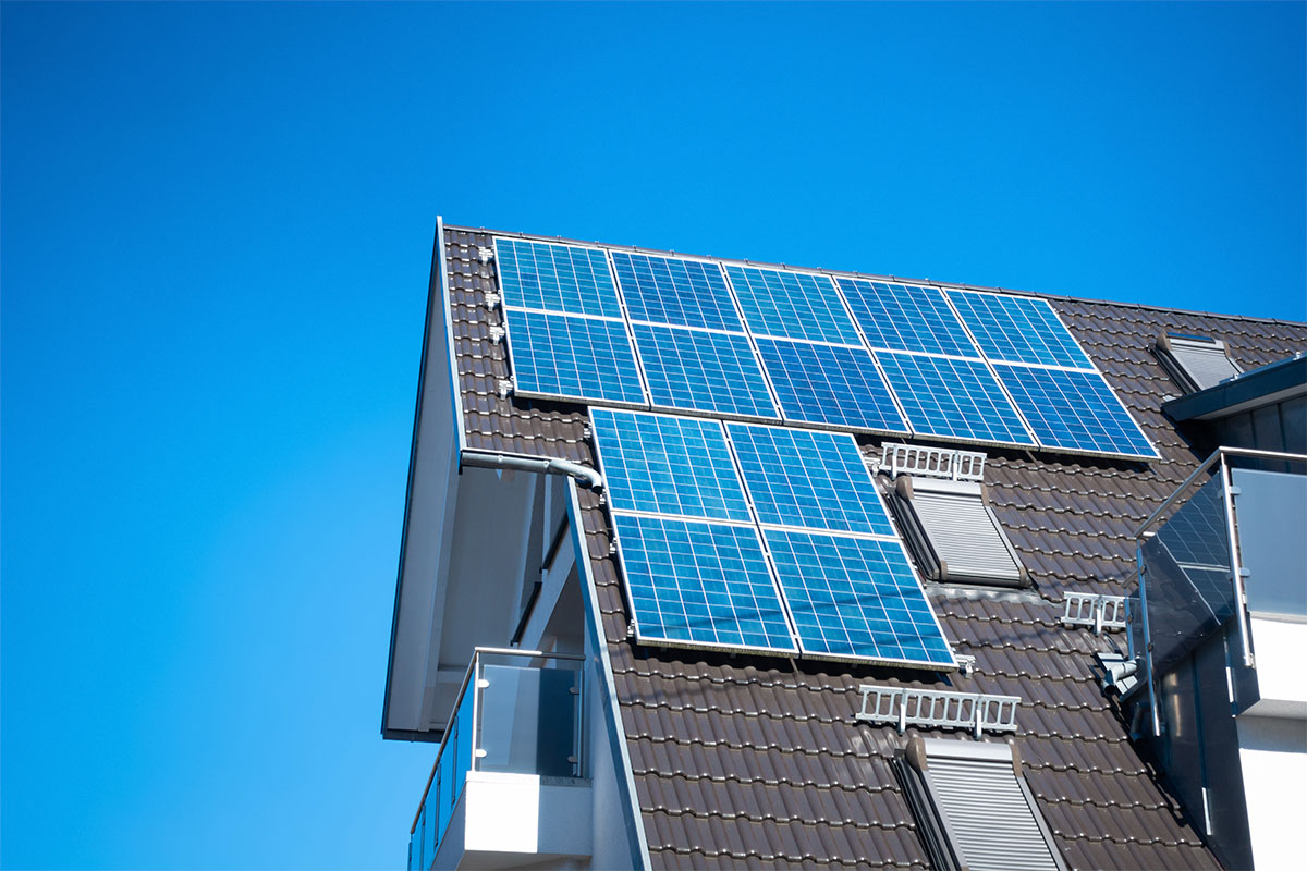Solar panels on the roof of a residential home and clear skies