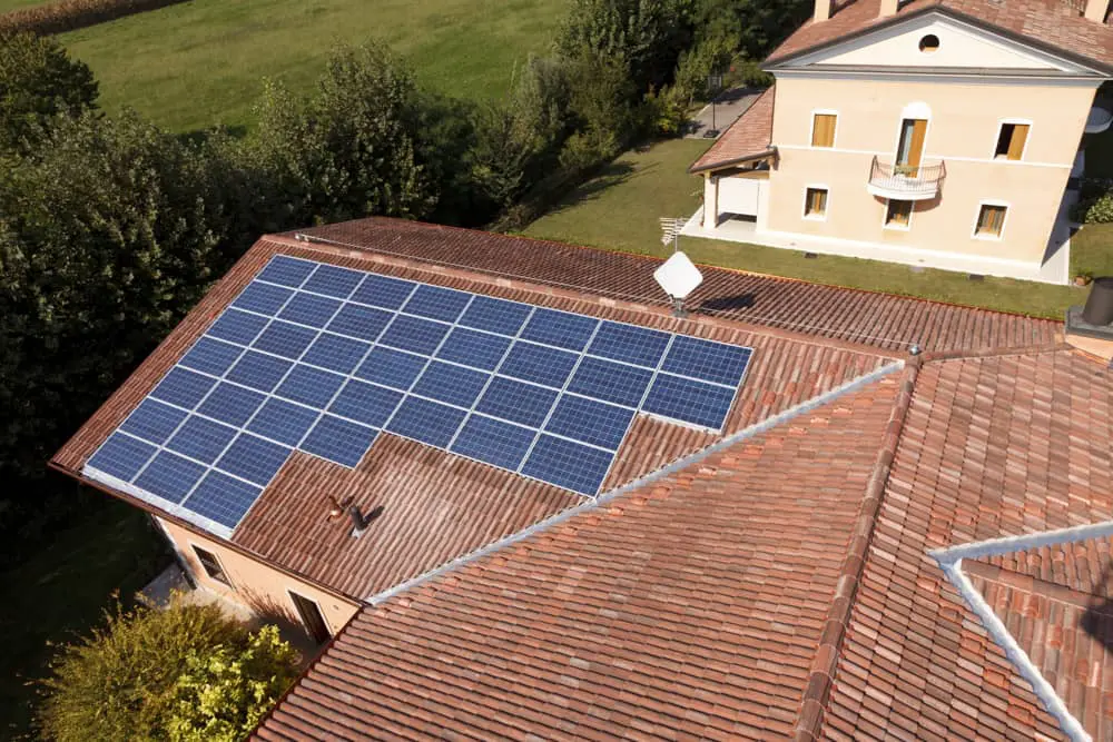 Drone view image of a residential home with solar panels