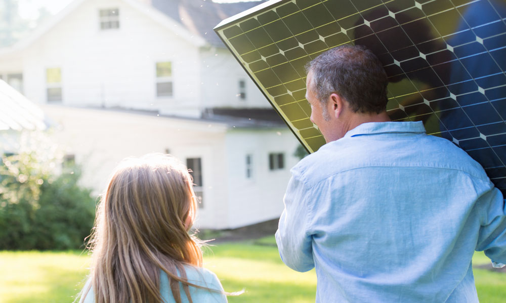 carrying-solar-panel man and his daughter carrying a rooftop solar panel