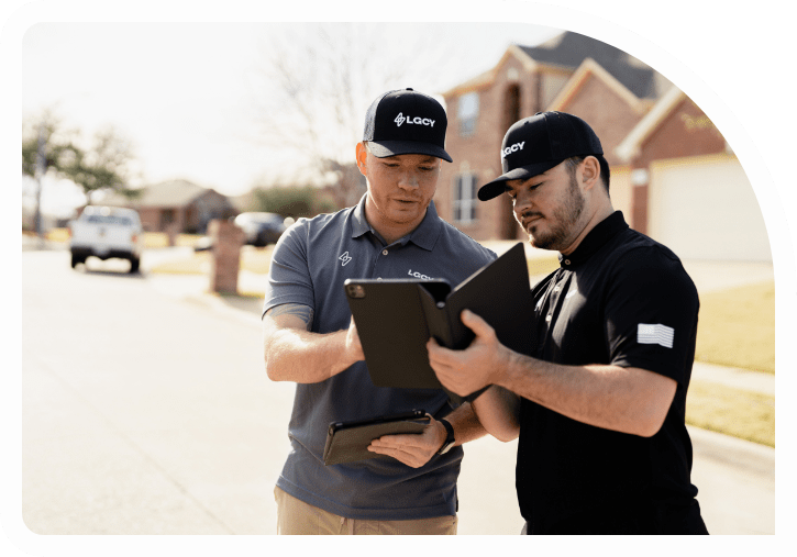 Two LGCY Power solar sale reps conversing with tablets