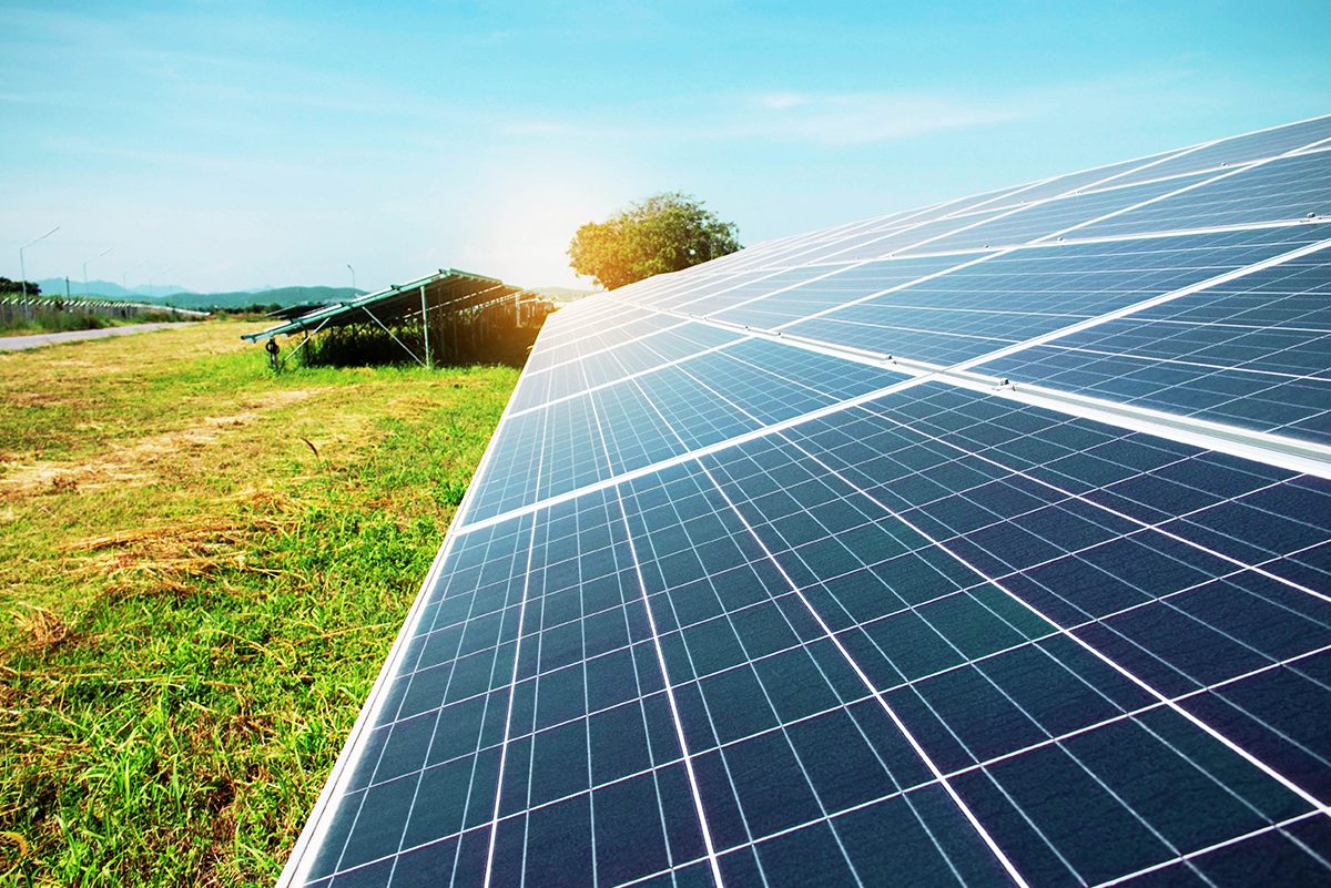 Solar panels on the lawn in the park with the sky.