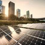 Solar panel city in front of a row of tall commercial buildings